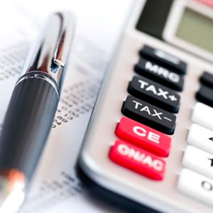 Image of calculator and a pen, preparing for income tax